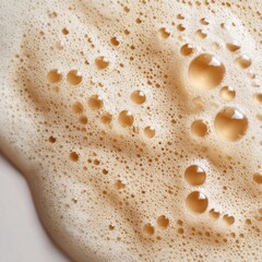 Close-up of light beige, foamy liquid with air bubbles