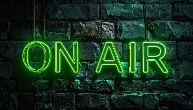 Captivating green neon "ON AIR" sign radiating a bright glow on a rugged dark brick wall, perfectly symbolizing a live recording or broadcasting event
