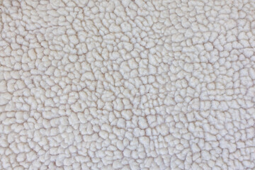 Macro texture of faux shearling fabric, soft fluffy textile background for winter fashion and design © Iryna Miadzvedzeva