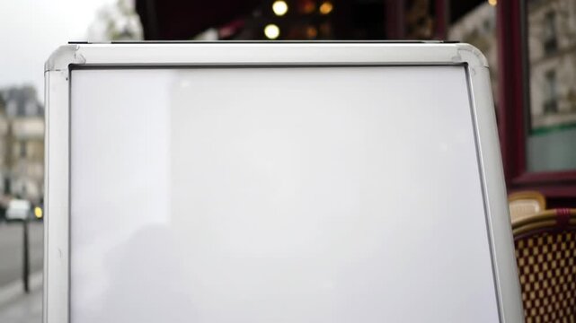 Blank White A-Frame Sign at an Outdoor Cafe, Perfect Mockup for Menu or Advertising