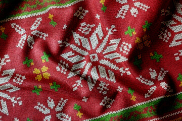 Seamless red Christmas fabric pattern with knitted texture, pixel-style festive design for holiday backgrounds, textiles. Cozy and traditional Christmas background evokes warmth and winter charm.