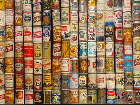 . A colorful selection of vintage canes of beer stacked in rows from an assortment of breweries.