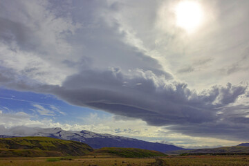 Majestic Icelandic landscape showcasing dramatic clouds over mountains and fields