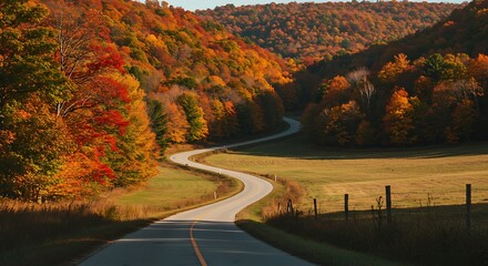 Scenic winding road through vibrant autumn forest landscape with colorful foliage