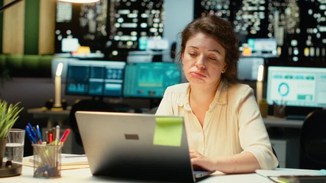 Tensed weary employee struggling with mental exhaustion and discomfort after hours, showing signs of intense workload and stress. Overwhelmed anxious woman with fatigue. Camera B.
