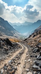 A dirt road winds through a mountain valley