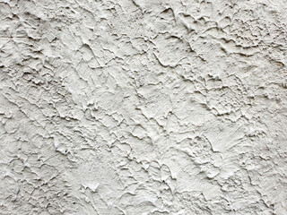 Textured white wall showcasing intricate patterns and variations in surface detail