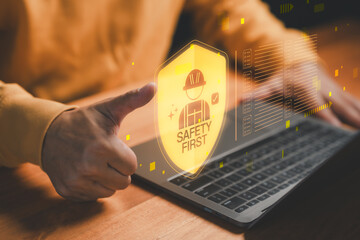 Safety first concept with worker protection icon and thumbs up on laptop, symbolizing workplace safety, industrial security and occupational health for business operations and construction management.
