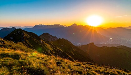 Mountain sunset with sun rays over rolling hills and valleys