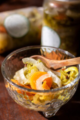 Glass Molcajete with Pickled Habanero Peppers and Wooden Spoon – Rustic Commercial Display with Jars in Background