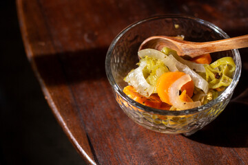 Rustic Glass Molcajete with Pickled Habanero Peppers and Wooden Spoon on Wooden Table