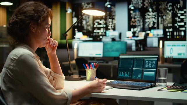 Woman accounting specialist reviews archived reports data for future strategy, using digital charts to plan resources allocation and align business goals with financial development. Camera A.