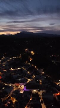 Night aerial drone view of Monda and its castle, Andalusia, Spain
