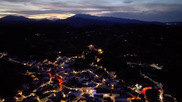 Night aerial drone view of Monda and its castle, Andalusia, Spain
