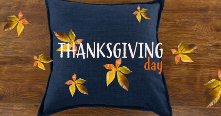 Image of thanksgiving day text over fall leaves and pillow