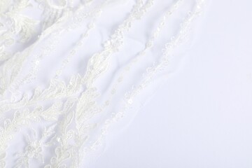Beautiful lace fabric on white background, closeup