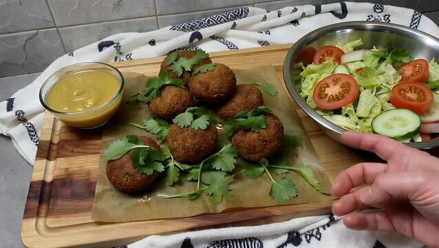 high-resolution moving capture of professionally assembled Middle Eastern chickpea-based dish