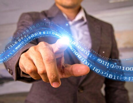 Businessman interacting with digital binary code
