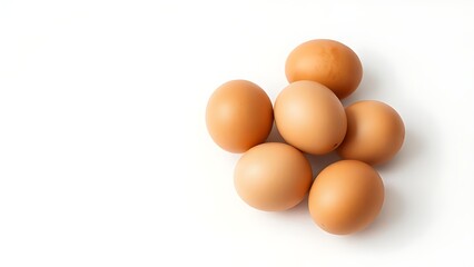 Brown eggs on a white surface, showcasing natural texture and subtle shadows in a minimalist composition.