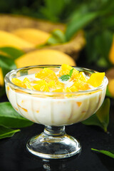 Tropical Mango Dessert with Fresh Yellow Fruit and Cream in Glass Bowl