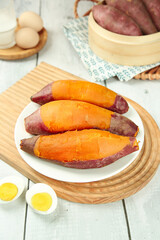Roasted Sweet Potatoes with Orange Flesh on Wooden Table - Healthy Natural Food Photography