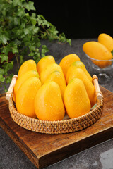 Fresh Xiaotainong Mangoes from Hainan China in Wicker Basket - Tropical Fruit Harvest Display