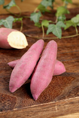 Fresh Sweet Potatoes with Pink Skin on Wooden Table - Healthy Organic Root Vegetable Ingredient