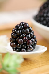Fresh Blackberry on White Spoon - Organic Berry Close-up on Wooden Surface