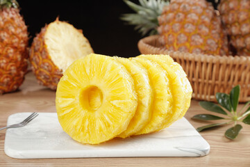 Fresh Golden Pineapple Slices on Marble Board with Whole Tropical Fruits in Rustic Kitchen Setting