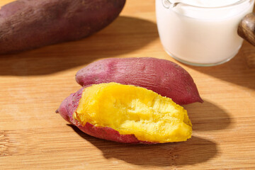 Fresh Roasted Sweet Potatoes with Golden Flesh on Wooden Board - Healthy Natural Food Ingredient