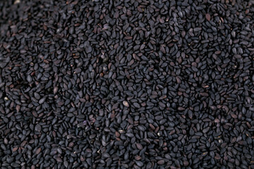 Black sesame seeds texture background - raw grains and cereals display for healthy cooking ingredients