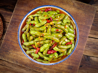 Spicy Edamame Beans with Red Chili Peppers in Bowl on Wooden Board - Traditional Asian Appetizer