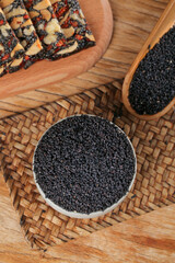 Black Sesame Seeds in Wooden Bowls on Bamboo Mat - Healthy Grains and Cereals for Cooking