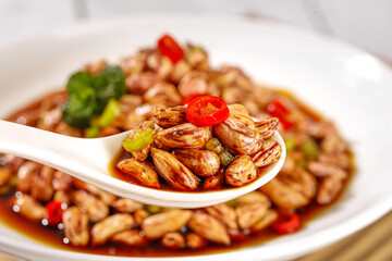 Spicy Boiled Peanuts with Chili Peppers - Traditional Asian Snack Food in White Ceramic Bowl