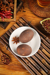 Traditional Chinese Tea Eggs with Star Anise and Spices on Bamboo Mat - Asian Cuisine Photography