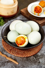 Gaoyou Salted Duck Eggs with Golden Runny Yolks in Traditional Chinese Bowl Setup