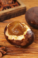Five spice sea duck preserved eggs Guangxi style traditional Chinese delicacy with oil glaze on rustic wooden background