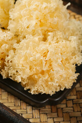Dried White Snow Fungus Tremella Traditional Chinese Medicine Ingredient on Bamboo Mat