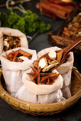 Collection of Hot Spices and Seasonings in Traditional Cloth Bags with Wooden Spoon