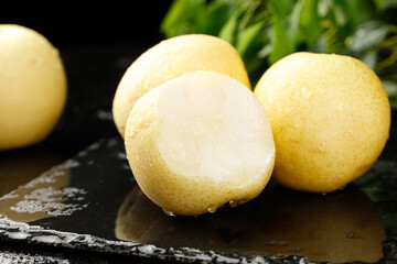 Fresh White Crown Pears from Hebei Province on Dark Slate Surface