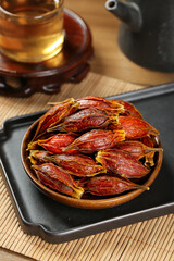 Dried Sichuan Gardenia Fruit Pods Traditional Chinese Herbal Medicine Spice in Wooden Bowl