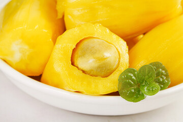 Fresh Golden Jackfruit Segments with Seeds on White Plate - Sweet Tropical Asian Fruit