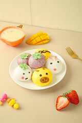 Cute Animal Face Steamed Buns Dim Sum with Fresh Fruit on White Plate - Colorful Asian Cuisine