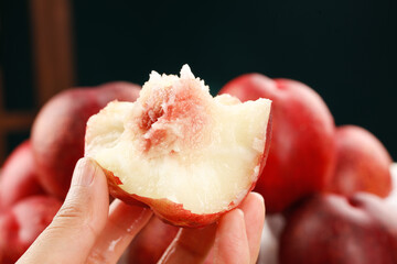 Premium Australian nectarine with white flesh and stone pit held in hand