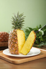 Fresh Golden Pineapple Cut in Half Showing Sweet Yellow Flesh on White Plate Ready to Eat