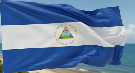 Nicaraguan flag waving against blue sky and ocean backdrop