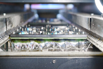 Wave soldering process for PCB tinning in a molten solder bath showcasing intricate details of assembly line technology