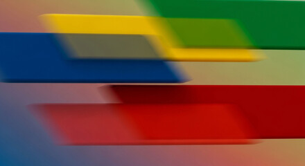 Abstract blurred motion background with colorful stripes of blue, yellow, red, and green creating a dynamic and vibrant visual effect for modern design