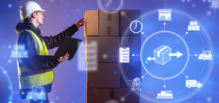 Logistics. Worker in safety vest and helmet using laptop while checking stacked boxes with digital supply chain icons, warehouse, transport, distribution, inventory. - Powered by Adobe