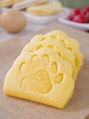 Adorable Paw Print Shaped Yellow Bread Slices on Wooden Cutting Board Kitchen Scene